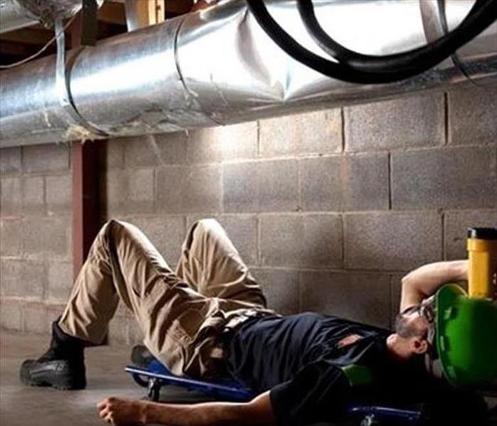 Here to Help - image of technician inspecting air duct