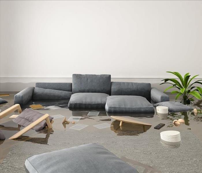 Pictured is a flooded room with a couch in the middle. 