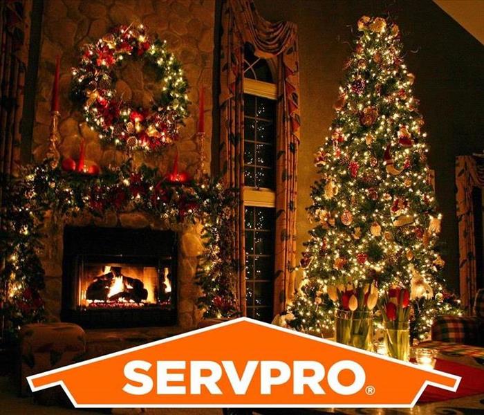 Pictured is a decorated Christmas themed living room and the servpro logo.